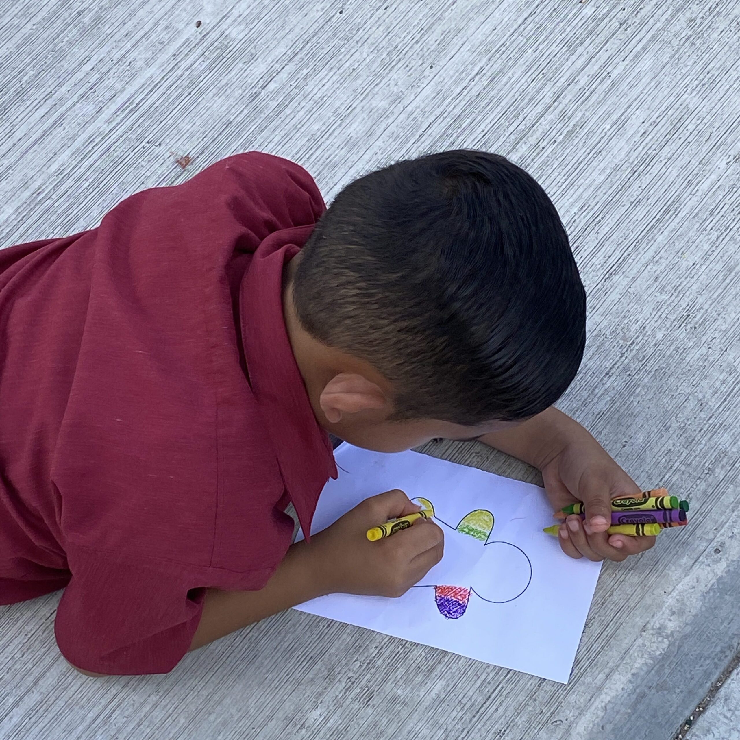 Boy coloring during Esme and Sadie's activity